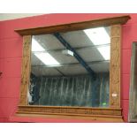 A large moulded and carved over mantle mirror