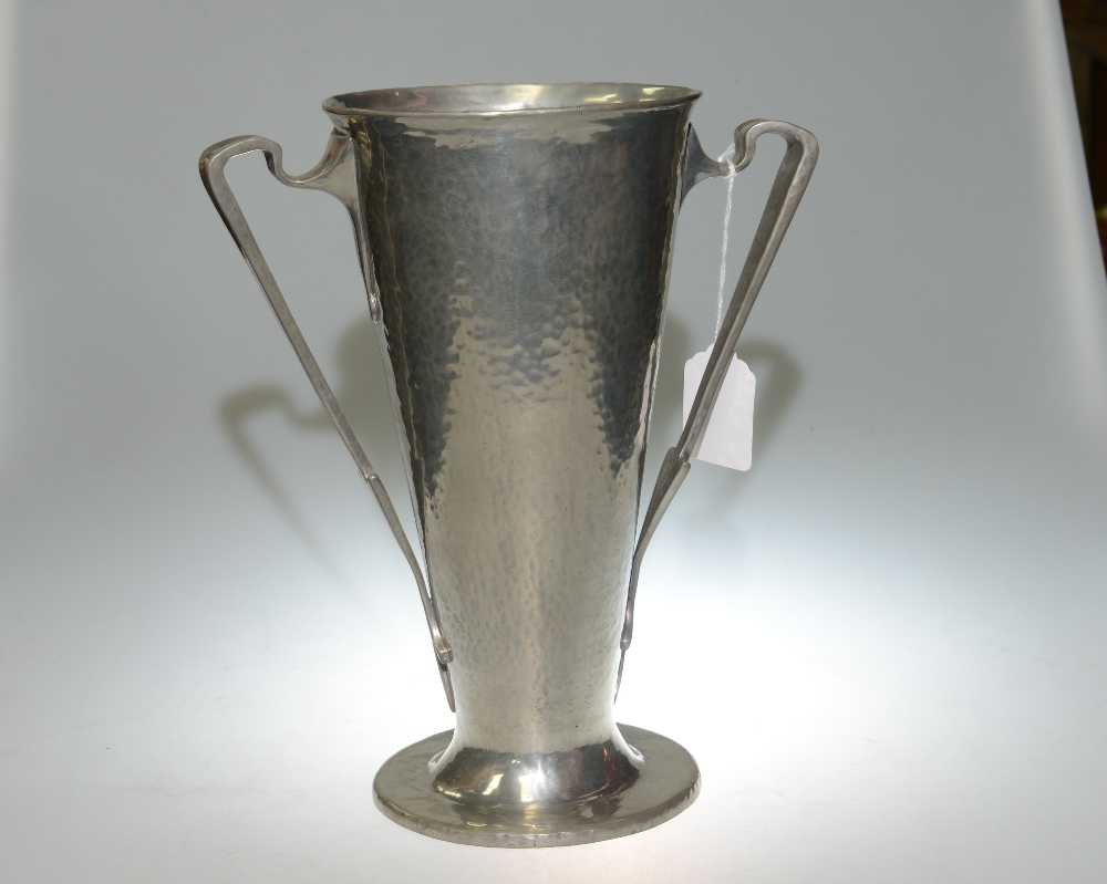 A Liberty & Co English pewter twin handled vase, the stylised twin handles applied to a hammered