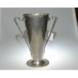 A Liberty & Co English pewter twin handled vase, the stylised twin handles applied to a hammered