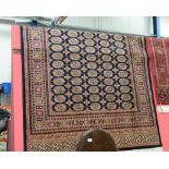 A Bokhara style rug with blue ground. 1.9m x 1.4m