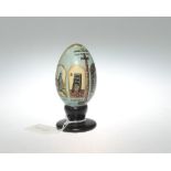 A painted egg with the Lord's prayer and religious vignettes