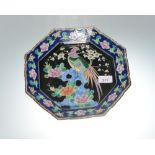 A Chinese enamel octagonal dish decorated with a pheasant amongst prunus