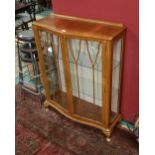 A 1930s walnut vitrine cabinet