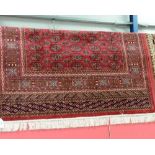 A Bokhara style rug with red ground. 1.9m x 1.4m