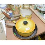 A group of four pieces of yellow Le Creuset