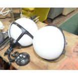 A pair of large globe shaped wall lights with black painted brackets