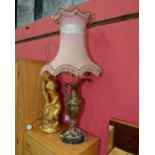 A gilt metal ewer form table lamp in period style on a marble plinth base