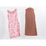 Two 1960's dresses comprising a brown sleeveless cocktail dress and a floral pink sleeveless with