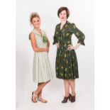 Two 1950's printed day dresses, one brushed cotton in greens yellows and browns, the other