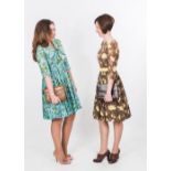 Two 1950's printed day dresses, one three quarter sleeve with yellow carnations on a brown ground,