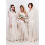 A vintage ivory lace wedding dress with veil