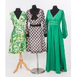 A group of three 1960's and 1970's dresses including a brown polka dot bow-front dress and a green