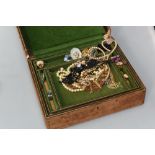 A 19th century gilt tooled leather jewellery box containing a quantity of vintage costume