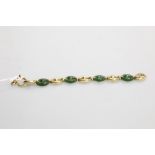 A substantial 18ct gold and jade bracelet, of pierced alternating oval links, stamped 750.