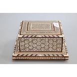 A mid-20th Century Damascus musical cigarette box inlaid with an intricate mosaic of mother of