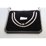 A diamond-set cultured pearl single strand necklace, the uniform row of cultured pearls each approx.