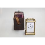 A small brass carriage clock and key, height 11cms,  in travelling case,