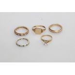 A group of five 9ct gold mounted rings comprising three gem set eternity rings, a solitaire ring and