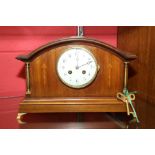 An Edwardian inlaid mahogany mantel clock, the white enamel dial with Arabic numerals, on a