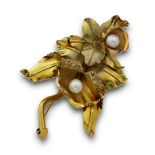 Broche naturalista en forma de orquídeas; realizado en lámina de oro de 18K con decoración grabada y