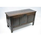 A late 17th century oak coffer with lift lid, triple-panel front, & carved frieze; 55¼" wide.