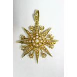 A 9ct. gold star brooch, all-over set graduated seed pearls, & with suspension loop for use as a