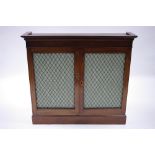 A 19th century mahogany dwarf bookcase enclosed pair brass grille doors, on plinth base; 40" wide.