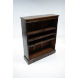 An Edwardian inlaid mahogany standing open bookcase fitted three adjustable shelves, on plinth base;