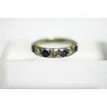 An 18ct. white gold ring set row of alternating diamonds & sapphires.
