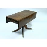 A regency mahogany Pembroke table on turned centre column & four splay legs with cast brass castors,