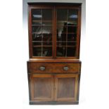 An early 19th century inlaid mahogany alcove secretaire bookcase enclosed pair glazed doors above