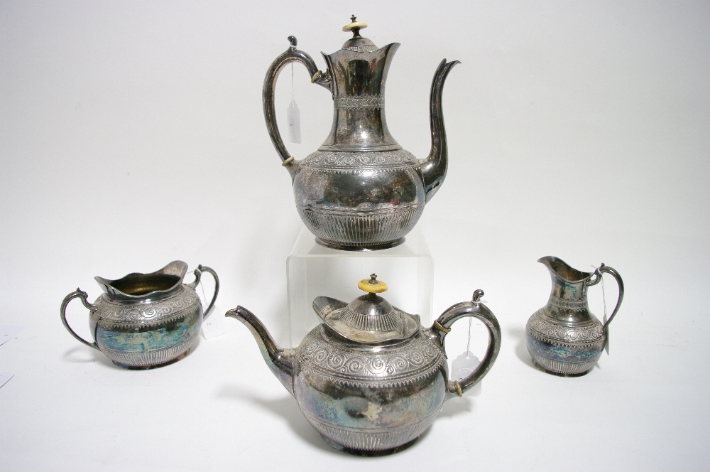 A late Victorian four-piece tea & coffee service of round semi-fluted design with scroll borders.