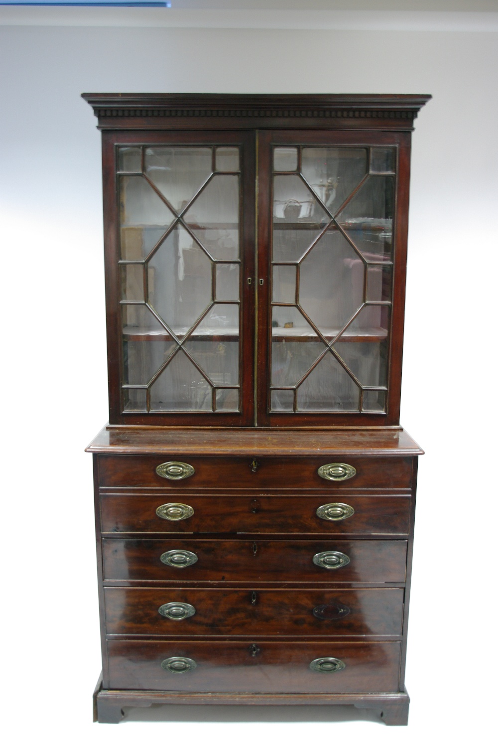 A late 18th century mahogany secretaire bookcase enclosed by a pair of astragal glazed doors, the