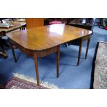 A George III style mahogany dining table with rounded corners to the rectangular end sections,