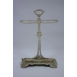 A Victorian cast-iron two-division umbrella stand with centre ring handle, 18½" wide x 28" high.