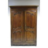 AN 18th century FRENCH OAK ARMOIRE with cavetto cornice, enclosed by a pair of carved panel doors