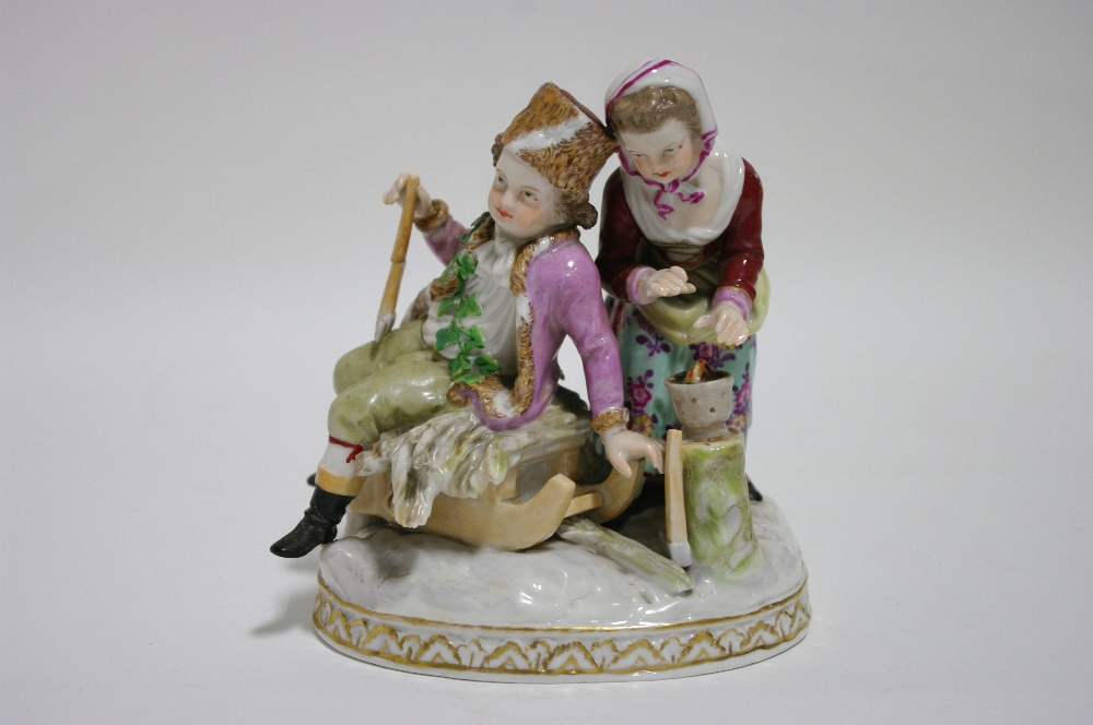 A Dresden porcelain figure group of male & female figures, emblematic of Winter, on oval base; 6"