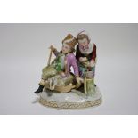 A Dresden porcelain figure group of male & female figures, emblematic of Winter, on oval base; 6"