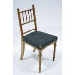 A Victorian oak occasional chair with spindle rail back, padded seat, & on turned tapered legs.