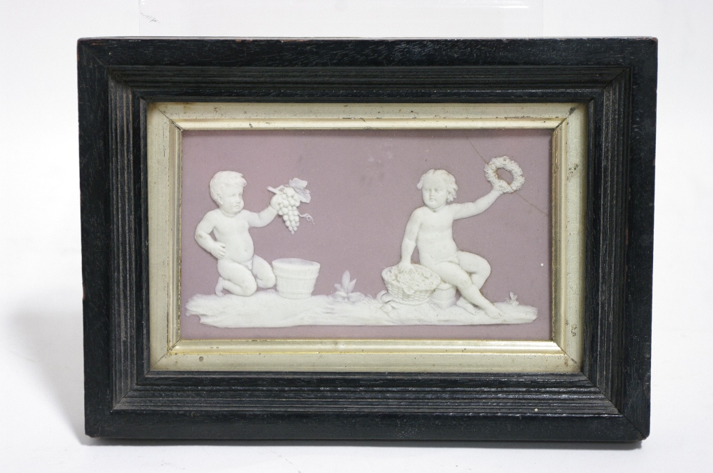 A Wedgwood lilac jasperware rectangular plaque decorated with Bacchanalian putti; 5½" x 3¼" (crack