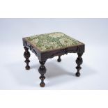 A 19th century continental walnut square stool with padded top, scroll frieze, & on four turned &