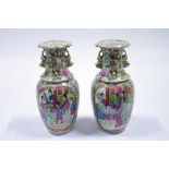 A pair of 19th century Cantonese ovoid vases painted with figure scenes in rose-verte enamels,