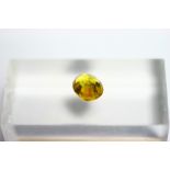 An un-mounted yellow sapphire, oval cut, measuring approx. 10mm x 8mm x 6mm deep.