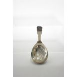 A George III Fiddle pattern caddy spoon, the wide oval bowl with pricked decoration of leaves &