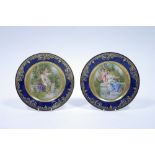 A pair of “Vienna” porcelain cabinet plates with raised gilding to the deep blue borders, the