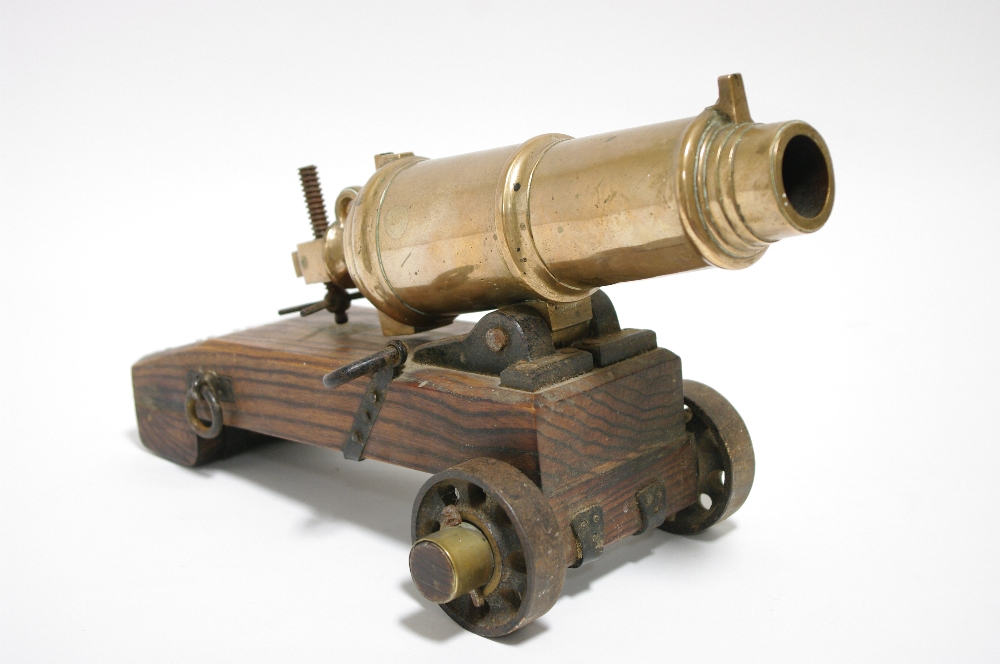 A bronze model canon, 11" long; on wooden limber & with iron fittings.