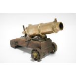 A bronze model canon, 11" long; on wooden limber & with iron fittings.