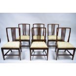 A set of six George III style mahogany dining chairs with rail backs, padded drop-in seats, & on