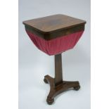 An early Victorian figured mahogany work table, the rectangular lift-top enclosing a work-basket