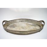 A large oval two-handled tea tray with gadrooned rim to the pierced gallery, on four bun feet; 26" x